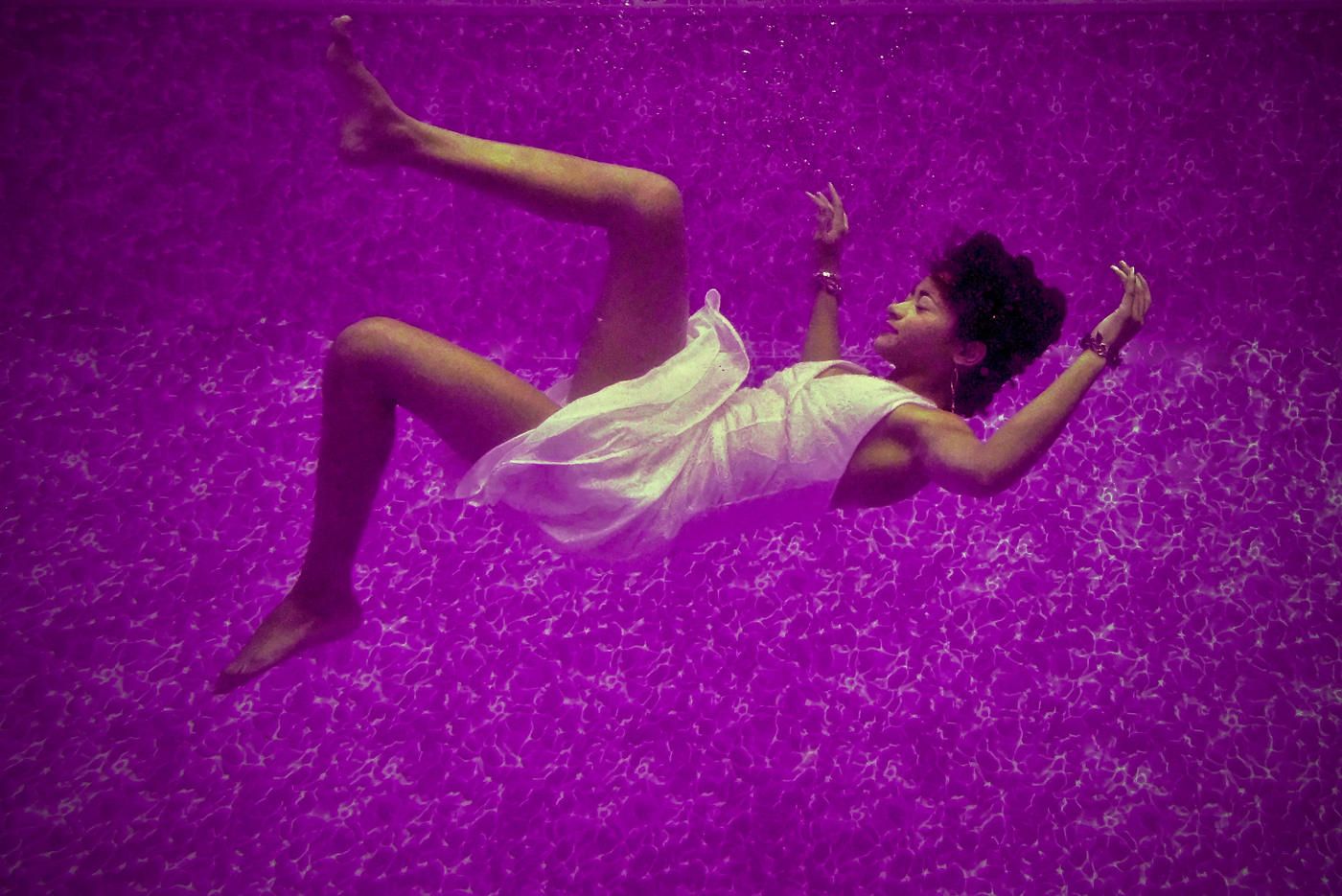 woman falling underwater purple