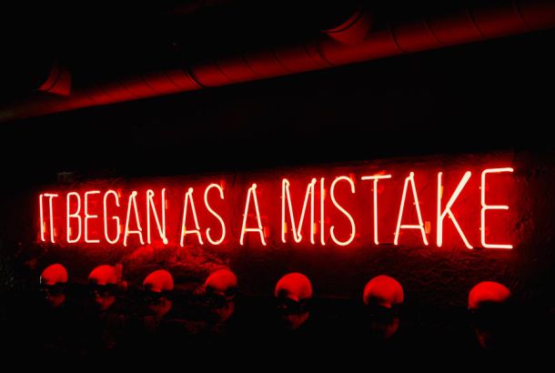 it began as a mistake red glowing sign